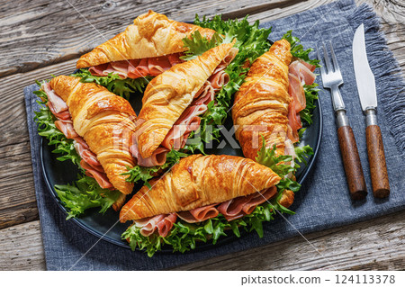 croissant sandwiches with ham and lettuce on plate croissant sandwiches with ham and lettuce on plate 124113378