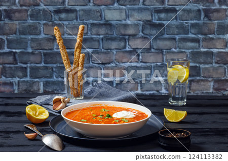 Red Lentil Tomato Soup with sour cream in a bowl Red Lentil Tomato Soup with sour cream in a bowl 124113382