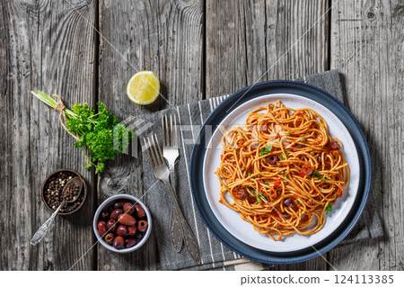 vegan whole grain pasta alla puttanesca on a plate vegan whole grain pasta alla puttanesca on a plate 124113385