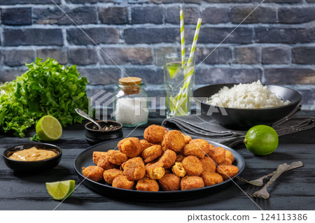 crunchy breaded salmon fish nuggets on plate 124113386