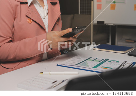 Cropped image of professional businesswoman working at her office via laptop, young female manager using portable computer device while sitting at modern loft, flare light, work process concept Cropped image of professional businesswoman working at her office via laptop, young female manager using portable computer device while sitting at modern loft, flare light, work process concept 124113698