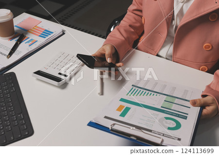 Cropped image of professional businesswoman working at her office via laptop, young female manager using portable computer device while sitting at modern loft, flare light, work process concept Cropped image of professional businesswoman working at her office via laptop, young female manager using portable computer device while sitting at modern loft, flare light, work process concept 124113699