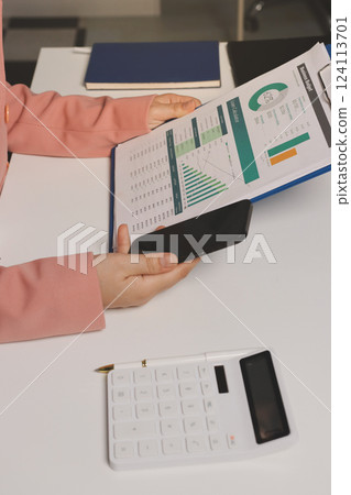 Cropped image of professional businesswoman working at her office via laptop, young female manager using portable computer device while sitting at modern loft, flare light, work process concept Cropped image of professional businesswoman working at her office via laptop, young female manager using portable computer device while sitting at modern loft, flare light, work process concept 124113701