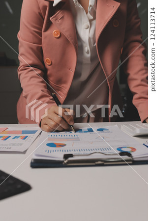 Cropped image of professional businesswoman working at her office via laptop, young female manager using portable computer device while sitting at modern loft, flare light, work process concept 124113714