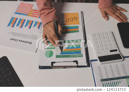 Cropped image of professional businesswoman working at her office via laptop, young female manager using portable computer device while sitting at modern loft, flare light, work process concept 124113715