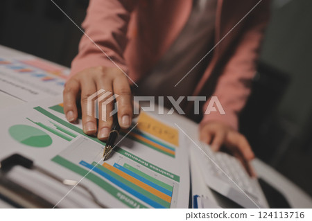 Cropped image of professional businesswoman working at her office via laptop, young female manager using portable computer device while sitting at modern loft, flare light, work process concept 124113716