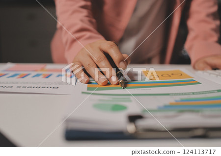 Cropped image of professional businesswoman working at her office via laptop, young female manager using portable computer device while sitting at modern loft, flare light, work process concept 124113717