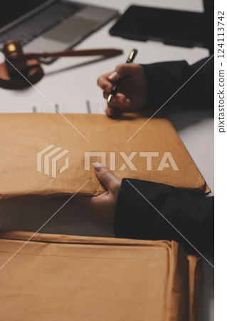 Judge gavel with Justice lawyers having team meeting at law firm background. Concepts of Law and Legal services. 124113742