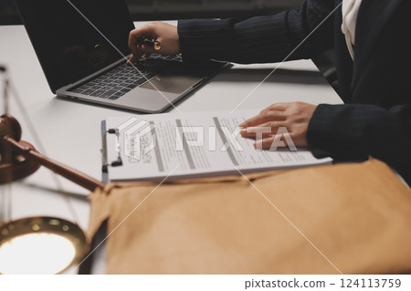 Judge gavel with Justice lawyers having team meeting at law firm background. Concepts of Law and Legal services. Judge gavel with Justice lawyers having team meeting at law firm background. Concepts of Law and Legal services. 124113759