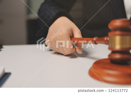 Judge gavel with Justice lawyers having team meeting at law firm background. Concepts of Law and Legal services. 124113772
