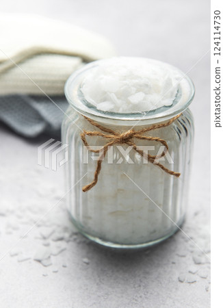 Magnesium flakes in glass jar for a relaxing bath with towels Magnesium flakes in glass jar for a relaxing bath with towels 124114730