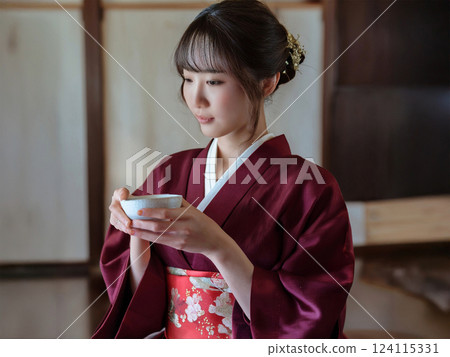 一位時尚的日本年輕女性以優美的舉止享用茶 124115331