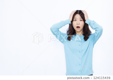 A surprised woman holding her head A surprised woman holding her head 124115439