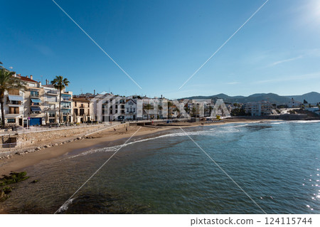 Picturesque townscape of Sitges with beachfront buildings and clear blue sky 124115744