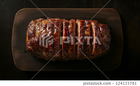 Golden-Brown Glazed Meatloaf on Dark Wooden Board 124115781