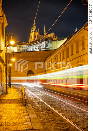 Vibrant light trails illuminate Letenska Street as trams pass, creating a lively atmosphere against the stunning backdrop of Prague Castle at night. Vibrant light trails illuminate Letenska Street as trams pass, creating a lively atmosphere against the stunning backdrop of Prague Castle at night. 124116097