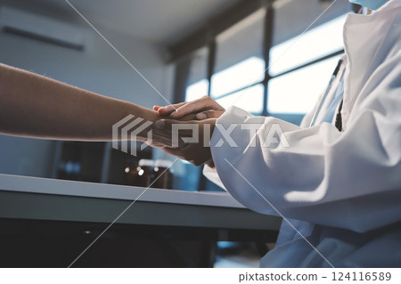 Closeup, doctor holding hands with senior woman and cancer care or support. Healthcare or trust, empathy or compassion and female caregiver or nurse holding elderly person hand for hope and kindness 124116589