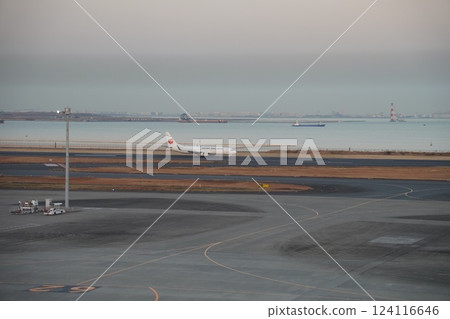 An airplane illuminated by the sunset 124116646