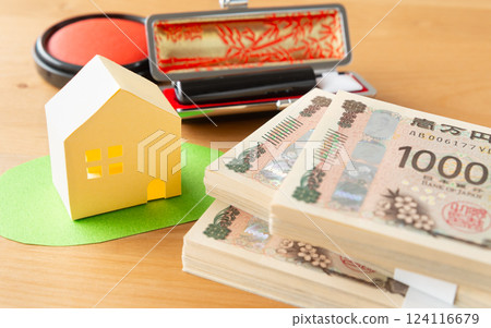 Real estate, a stack of bills and a stamp 124116679