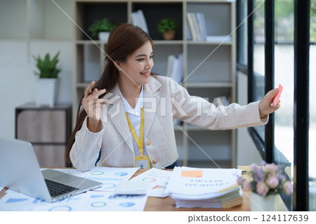 professional businesswoman with planning takes a notepad financial documents and marketing charts at work 124117639