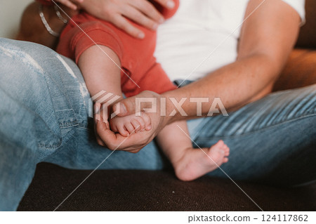 Parent Holding Baby's Foot in Gentle Embrace Parent Holding Baby's Foot in Gentle Embrace 124117862