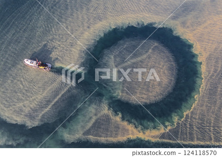 Image of the researching ship looking for fish in the blurred sea after rain and storm. 124118570