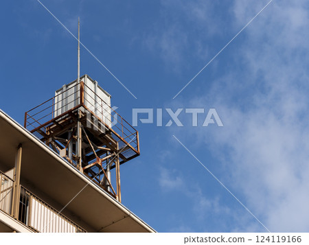 Old rooftop water supply system installed in an abandoned housing complex 124119166