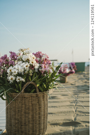 Basket of Flowers on Sandy Beach in Tranquil Setting 124119561