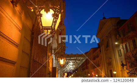 Close up of illuminated street lamps on a building in Nice, France 124120049