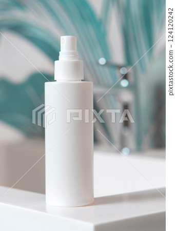White cosmetic spray bottle on washbasin with faucet in green tropical bathroom close up, mockup White cosmetic spray bottle on washbasin with faucet in green tropical bathroom close up, mockup 124120242
