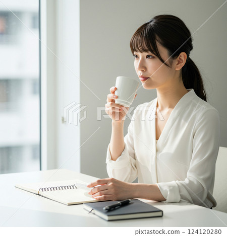 Woman working while drinking coffee 124120280