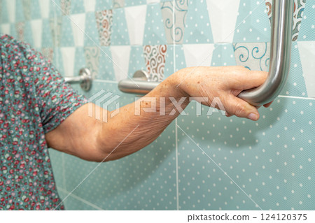 Asian elderly woman patient use toilet bathroom handle security in nursing hospital, healthy strong medical. 124120375