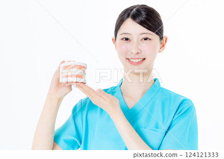 Dental hygienist with toothbrush 124121333
