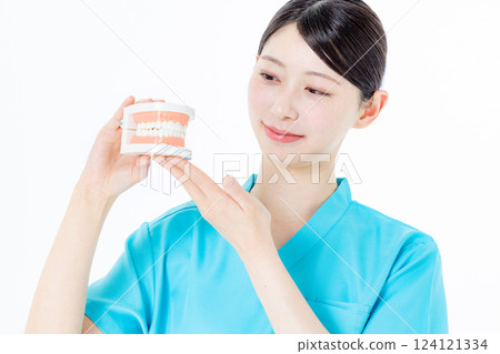Dental hygienist with toothbrush 124121334