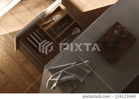 wabi-sabi kitchen features a warm grey island, an open counter adorned with oak inserts showcasing neatly arranged cutlery, a soft linen towel draped gracefully, and a delicate Japanese tea set atop, wabi-sabi kitchen features a warm grey island, an open counter adorned with oak inserts showcasing neatly arranged cutlery, a soft linen towel draped gracefully, and a delicate Japanese tea set atop, 124121640