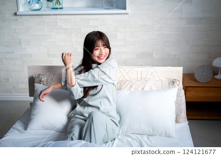 Women stretching in bed Women stretching in bed 124121677