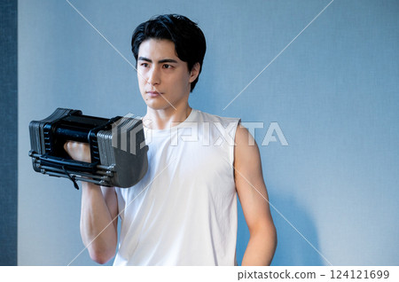 Man doing muscle training with dumbbells 124121699