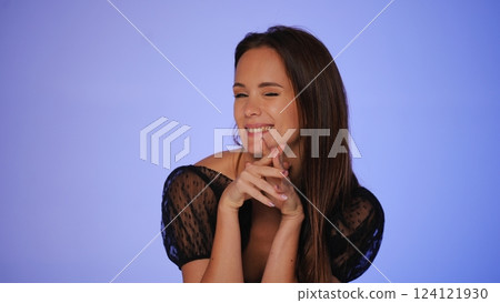 Playful woman winking with a cheerful smile Playful woman winking with a cheerful smile 124121930