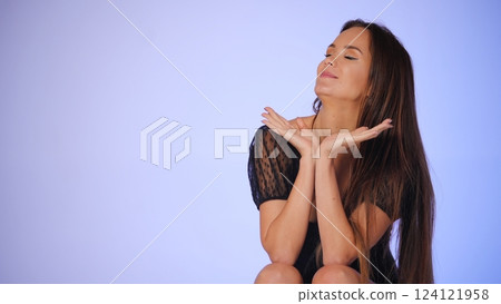 Relaxed beauty blogger enjoying a self-care moment with closed eyes  124121958