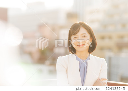 A middle-career woman taking a break on the roof A middle-career woman taking a break on the roof 124122245