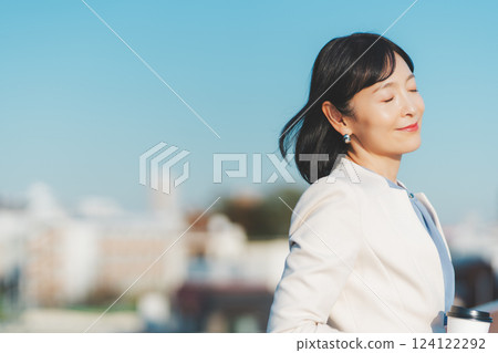 A middle-career woman blowing in the winds of the city 124122292