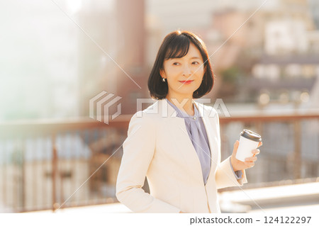 A middle-career woman taking a break on the roof A middle-career woman taking a break on the roof 124122297