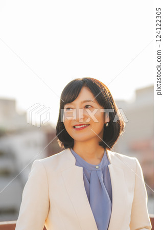 A middle-career woman taking a break on the roof 124122305