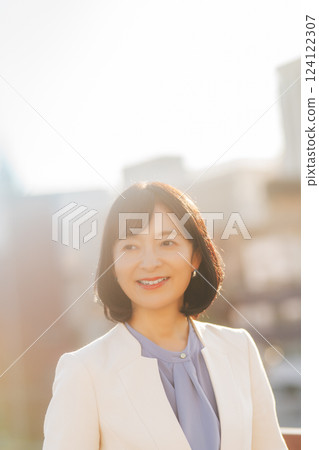 A middle-career woman taking a break on the roof A middle-career woman taking a break on the roof 124122307