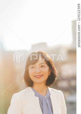 A middle-career woman taking a break on the roof A middle-career woman taking a break on the roof 124122309
