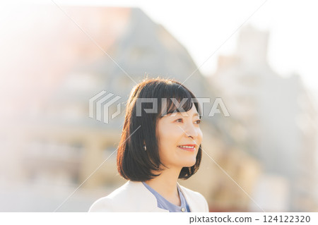 A middle-career woman taking a break on the roof 124122320