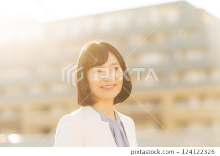A middle-career woman taking a break on the roof 124122326