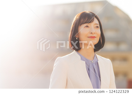 A middle-career woman taking a break on the roof A middle-career woman taking a break on the roof 124122329