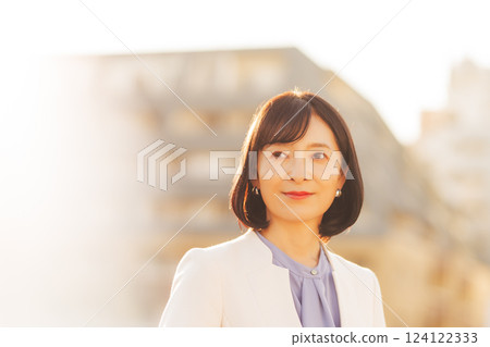 A middle-career woman taking a break on the roof A middle-career woman taking a break on the roof 124122333
