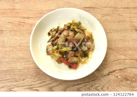 spicy stir fried ostrich meat with onion and black pepper on plate  124122764